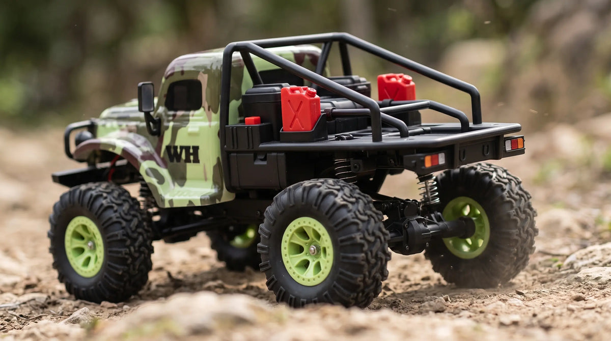 A detailed shot of a camouflage remote control (RC) crawler truck with bright green wheels and scale accessories, driving over rocky outdoor terrain.
