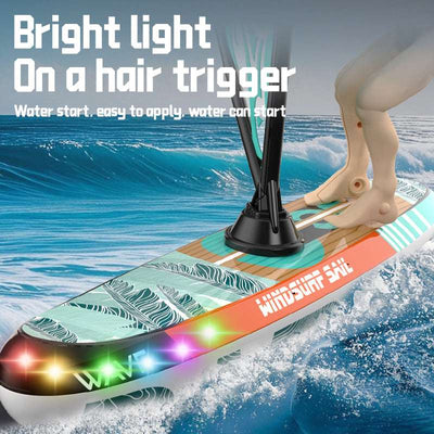 PLAYPULSE remote control racing sailboat with led lights glowing on sailboard in water action scene